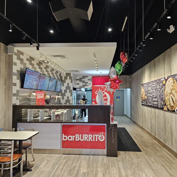 Completed QSR fit-out interior with branded counter and digital menu boards
